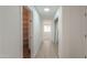 Bright hallway with tile floor leading to a pantry and closet for added storage at 43601 W Cowpath Rd, Maricopa, AZ 85138
