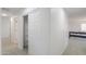 Bright hallway features a closet, neutral carpet, and white walls at 43601 W Cowpath Rd, Maricopa, AZ 85138