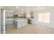 Updated kitchen with gray cabinets, stainless steel appliances, and center island on neutral tile floor at 43601 W Cowpath Rd, Maricopa, AZ 85138