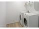 Laundry room with washer and dryer and built-in shelves at 43601 W Cowpath Rd, Maricopa, AZ 85138