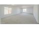 Bright living room with neutral carpet, natural light, and a welcoming atmosphere at 43601 W Cowpath Rd, Maricopa, AZ 85138