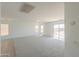 Open-concept living space featuring neutral carpet, large windows, and bright, natural light at 43601 W Cowpath Rd, Maricopa, AZ 85138