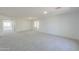 Spacious living room with neutral carpet, a large window and ample natural light at 43601 W Cowpath Rd, Maricopa, AZ 85138