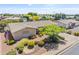 Aerial view of a well-maintained home with landscaped front yard, mature trees, and a tidy driveway at 6631 E Dallas St, Mesa, AZ 85205