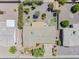 An aerial view of a home with a spacious backyard, patio, and lush landscaping including gravel and various trees at 6631 E Dallas St, Mesa, AZ 85205