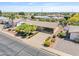 Overhead view of a single-story home with a covered carport, neat landscaping, and neighborhood streets at 6631 E Dallas St, Mesa, AZ 85205