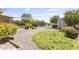 Landscaped backyard featuring mature plants, desert landscaping, and a detached storage shed at 6631 E Dallas St, Mesa, AZ 85205