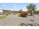 Spacious backyard with desert landscaping, mature trees, and a shaded patio area at 6631 E Dallas St, Mesa, AZ 85205