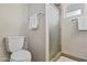 Bright bathroom featuring a toilet, shower with glass door, neutral wall color and coordinated towel bars at 6631 E Dallas St, Mesa, AZ 85205