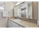 Bathroom showcasing a large mirror, vanity with solid surface countertops, and a glass-enclosed shower at 6631 E Dallas St, Mesa, AZ 85205