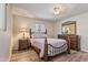 Bedroom featuring wood-look floors, wrought iron bed frame, and matching dresser and mirror at 6631 E Dallas St, Mesa, AZ 85205