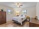 Comfortable bedroom with wood floors, ceiling fan, and two windows providing lots of natural light at 6631 E Dallas St, Mesa, AZ 85205