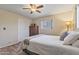 Bedroom featuring wood floors, a ceiling fan, closet with sliding doors, and natural light at 6631 E Dallas St, Mesa, AZ 85205