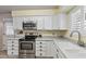 Updated kitchen with stainless steel appliances, white cabinetry, and ample counter space at 6631 E Dallas St, Mesa, AZ 85205