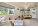 Bright living area with wicker furniture, ample natural light, and views of the surrounding landscape at 6631 E Dallas St, Mesa, AZ 85205