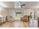 Inviting living room with wood-look flooring, a decorative window, and comfortable seating at 6631 E Dallas St, Mesa, AZ 85205