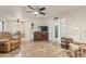 Living room features wood floors, ceiling fan, and multiple seating options including a large, comfortable recliner at 6631 E Dallas St, Mesa, AZ 85205