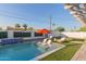 Inviting backyard features a pool, lounge chairs, and an orange umbrella at 8522 E Virginia Ave, Scottsdale, AZ 85257