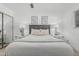 Bedroom with a large bed, two side tables with lamps, a soft throw blanket, and two pieces of framed wall art at 8522 E Virginia Ave, Scottsdale, AZ 85257