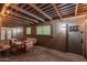 Covered patio with exposed beams, outdoor seating, and a doorway to the interior of the home at 8522 E Virginia Ave, Scottsdale, AZ 85257