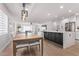 Open-concept dining area next to a kitchen with stainless steel appliances and a sun-filled living space at 8522 E Virginia Ave, Scottsdale, AZ 85257