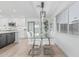 Open dining area features a modern light fixture and a glass top dining table at 8522 E Virginia Ave, Scottsdale, AZ 85257