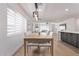 Bright dining room features a modern chandelier and flows seamlessly into the cozy living area and updated kitchen at 8522 E Virginia Ave, Scottsdale, AZ 85257