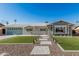 Charming home with a well-manicured lawn, paver pathway, and neutral-toned exterior at 8522 E Virginia Ave, Scottsdale, AZ 85257