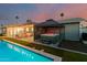 Hot tub with cover and steps, surrounded by a manicured lawn, part of an outdoor living space at 8522 E Virginia Ave, Scottsdale, AZ 85257