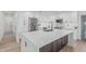 Bright kitchen features stainless appliances, white cabinets, and center island with stone countertop at 8522 E Virginia Ave, Scottsdale, AZ 85257
