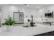 Contemporary kitchen featuring white cabinetry, stainless steel appliances, and marble countertops at 8522 E Virginia Ave, Scottsdale, AZ 85257