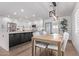 Modern kitchen boasts white cabinets, stainless steel appliances, and a dining area with views through double doors at 8522 E Virginia Ave, Scottsdale, AZ 85257