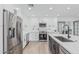 Bright kitchen features stainless appliances, white cabinets, and center island with seating at 8522 E Virginia Ave, Scottsdale, AZ 85257