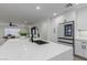 Modern kitchen with white cabinets, stainless appliances, quartz countertops, and black hardware at 8522 E Virginia Ave, Scottsdale, AZ 85257