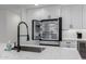 Modern white kitchen with stainless steel refrigerator and gourmet appliances, open shelving, and ample storage at 8522 E Virginia Ave, Scottsdale, AZ 85257