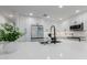 Modern kitchen with white cabinets, stainless steel appliances, and a sleek island sink at 8522 E Virginia Ave, Scottsdale, AZ 85257