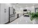 Bright, updated kitchen features white cabinets, stainless appliances, quartz countertops, and black hardware at 8522 E Virginia Ave, Scottsdale, AZ 85257