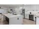 Open concept kitchen features a large island, stainless steel refrigerator, and modern finishes at 8522 E Virginia Ave, Scottsdale, AZ 85257