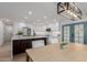Eat-in kitchen with large island and dark wood accents, white cabinets, and stainless steel fridge at 8522 E Virginia Ave, Scottsdale, AZ 85257