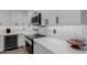 Updated kitchen features white cabinets, stainless appliances, and quartz countertops at 8522 E Virginia Ave, Scottsdale, AZ 85257