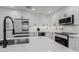 Updated kitchen with white cabinets, stainless appliances, and quartz countertops at 8522 E Virginia Ave, Scottsdale, AZ 85257