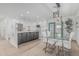 Bright kitchen features stainless appliances, waterfall island, and adjacent dining space at 8522 E Virginia Ave, Scottsdale, AZ 85257