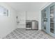 Bright laundry room featuring new appliances, patterned tile floors, blue door, and shelving at 8522 E Virginia Ave, Scottsdale, AZ 85257