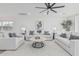Inviting living room features ceiling fan, wood floors, and stylish white furniture at 8522 E Virginia Ave, Scottsdale, AZ 85257