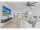 Open concept living area showcases sleek mounted television, bright kitchen, and modern furniture at 8522 E Virginia Ave, Scottsdale, AZ 85257