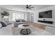 A spacious, beautifully decorated living room features a large window, modern furniture, and a stylish ceiling fan at 8522 E Virginia Ave, Scottsdale, AZ 85257