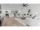 Bright living room features sleek ceiling fan, wood floors, and stylish white furniture at 8522 E Virginia Ave, Scottsdale, AZ 85257