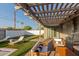 Covered patio with comfortable seating, views of the backyard with lounge chairs and artificial turf at 8522 E Virginia Ave, Scottsdale, AZ 85257