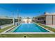 Backyard pool with a waterfall feature, surrounded by lush green turf and lounging areas at 8522 E Virginia Ave, Scottsdale, AZ 85257