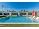Backyard pool features a cascading water feature, lounge chairs and an umbrella with turf surround at 8522 E Virginia Ave, Scottsdale, AZ 85257